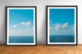 Framed picture prints of ocean and blue sky landscape photography on wooden floor Royalty Free Stock Photo