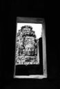 Framed by the stone with buddha face in Angkor Wat in black and Royalty Free Stock Photo