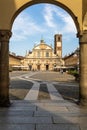 Framed view through the arches of the historic Piazza Ducale and the Cathedral of Saint Ambrose in Vigevano. Royalty Free Stock Photo
