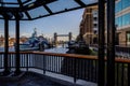 Framed view of HMS Belfast and Tower Bridge from The South Bank, London, UK