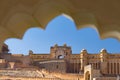 Framed view of the honey toned impressive Amber Fort, famous tourist attraction at Jaipur, Rajasthan, India. Daylight, clear blue Royalty Free Stock Photo