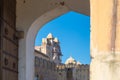 Framed view of the honey toned impressive Amber Fort, famous tourist attraction at Jaipur, Rajasthan, India. Daylight, clear blue Royalty Free Stock Photo