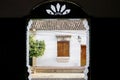 Framed view to a typical historic white building with wooden window, Santa Cruz de Mompox, Colombia, World Heritage