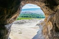Framed view of valley from inside Uplistsikhe Cave Town - Ancient pre-christian rock-hewn town and monastery in Georgia Eastern