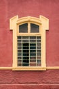 Framed window on a red wall as seen from exterior Royalty Free Stock Photo
