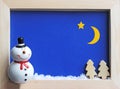 Framed winter scene with a snowman at night Royalty Free Stock Photo