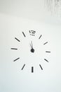 Frameless wall clock on white concrete wall. Minimalizm