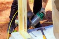 Framer uses an air nail hammer to install beams in a wooden frame