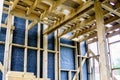 Framework of the house wall, of boards and timber, a window, a vapor barrier Royalty Free Stock Photo