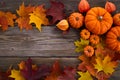 Framework with pumpkins and fall leaves on wooden background. Top view. Royalty Free Stock Photo