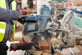 Framing contractor using a circular cut off saw to trim wood studs to length