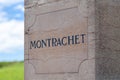 France Burgundy 2019-06-20 closeup stone pillows with vintage plate, nameboard of Montrachet grand cru vineyard