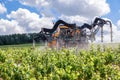 France Chablis 2019-06-21 Orange tractor spraying vineyard with sulfur Royalty Free Stock Photo