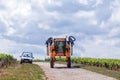 France Chablis 2019-06-21 tractor to cultivate field, working on vineyard. Farmer watering vineyards with tractor