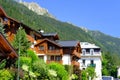 France, Chamonix Mont Blanc, August 2021: summer city with view of Alps mountains, houses decorated with flowers, people, tourists