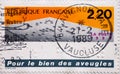 FRANCE - CIRCA 1989: a postage stamp printed in France showing a graphic with braille. Text: in favor of the blind