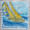 FRANCE - CIRCA 1993 : a postage stamp printed in France showing a sports sailor in high waves with people and sails set. Text: Sai