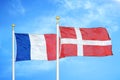 France and Denmark two flags on flagpoles and blue cloudy sky Royalty Free Stock Photo