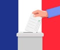 France election concept. Hand puts vote bulletin