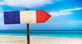 France flag on wooden table sign on beach background. It is summer sign of France Royalty Free Stock Photo