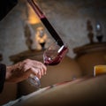 FRANCE, GIRONDE, SAINT-EMILION, SAMPLING A GLASS OF WINE IN A BARREL WITH A PIPETTE FOR TASTING AND VINIFICATION Royalty Free Stock Photo