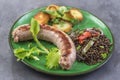 France Grilled Toulouse sausage with roasted potatoaes and salad and lentils on old wooden background Royalty Free Stock Photo