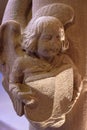 Simple carved stone angel holding a book