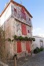 France Isle of Re historical old stone house with red shutters Royalty Free Stock Photo