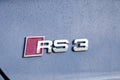 France Lyon 2019-06-20 closeup brand logo of premium sports car dark gray hatchback Audi RS 3, low profile tires, cast disk, red