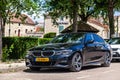 France Lyon 2019-06-20 closeup luxury dark blue German car sedan premium BMW 5 series with EU registration number on parking small