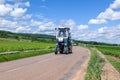 France Lyon 2019-06-20 Winemaking equipment, vineyard harvesting machine, blue tractor Faupin Bobard with driver. Concept of