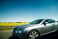 Luxury silver Bentley driving fast on highway in France