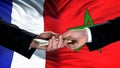 France and Morocco officials exchanging money, flag background, business deal