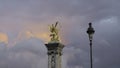 France, Paris - July 24, 2022: Golden statue on tower on background of clouds. Action. Beautiful landscape with golden