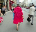 France, Paris, Rue de Rennes, woman in red balloon coat and hat
