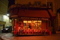 Very cute, colorful and pink cafe facade in Paris Street during night.