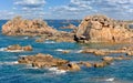 France, Pink Granite Coast. Textured rock formations and crystal clear blue water in Perros-Guirec, Brittany, France. Royalty Free Stock Photo