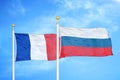France and Russia two flags on flagpoles and blue cloudy sky Royalty Free Stock Photo