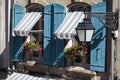 France south provence style cottage windows, blue shutters and flower boxes Royalty Free Stock Photo