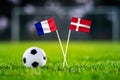 France vs. Denmark, Stadium 974, Football match wallpaper, Handmade national flags and soccer ball on green grass. Football Royalty Free Stock Photo