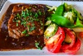 Franch meal with tomato and beans salad, french fries and steak with souse