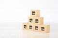 Close-up cube wooden toy block stack in pyramid with franchises store icon for small business standard and best quality