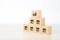 Close-up hand choose cube wooden toy block stack with franchises business store icon