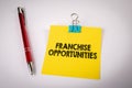 Franchise Opportunities. Text on yellow notepad, white office table Royalty Free Stock Photo