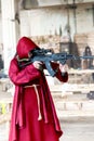 Franciscan monk aiming with rifle