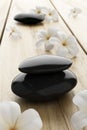 Frangipani flower and black stone, zen spa on wood