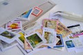 Frankfurt - August 2021: large set of mixed parts of envelopes and postage stamps from different countries, philatelist tweezers,