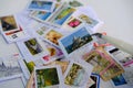 Frankfurt - August 2021: large set of mixed parts of envelopes and postage stamps from different countries, philatelist tweezers,