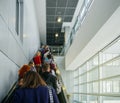 Passengers commuting on the escalator in modern airport terminal Royalty Free Stock Photo