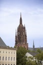 The clock tower of Saint Bartholomew Cathedral rises over houses in Frankfurt, Germany